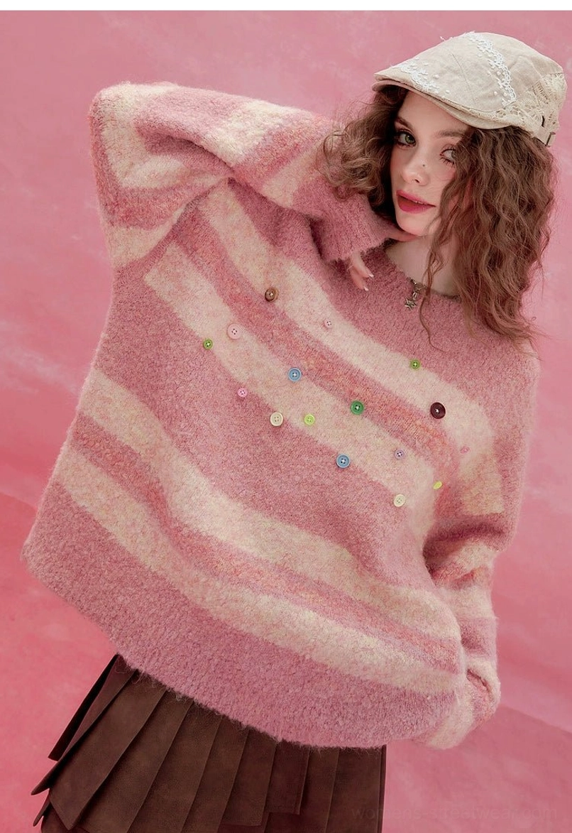 Detailed side close-up of pink striped fuzzy knit sweater with colorful buttons and plush texture