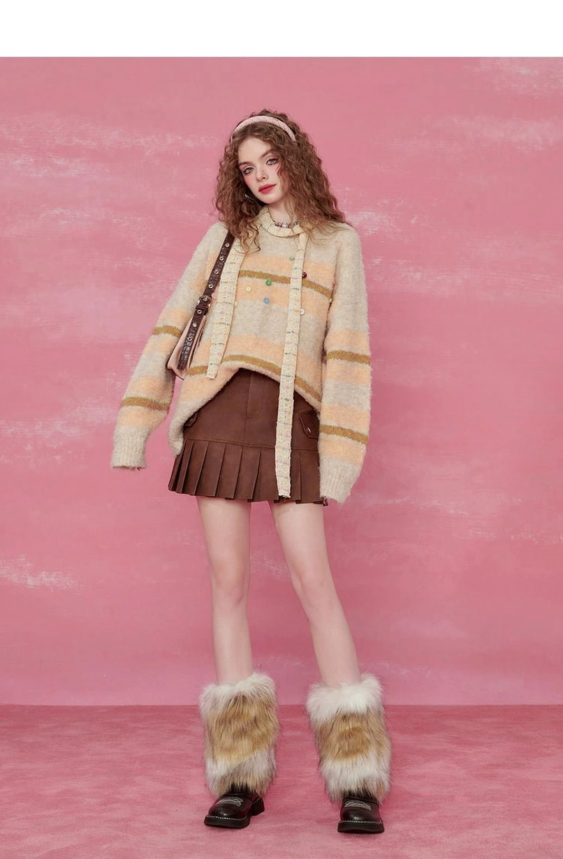 Pink striped fuzzy knit sweater showing soft brushed yarn and colorful decorative button details