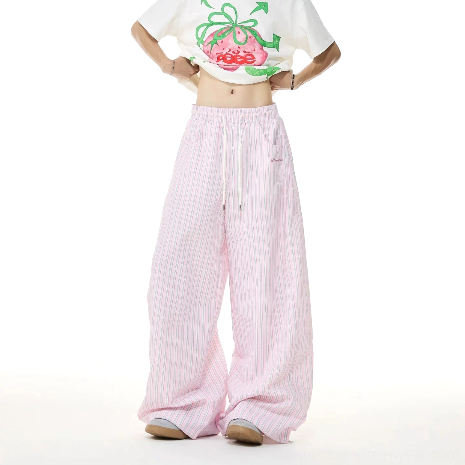 Front full-body view of pink and white striped oversized wide-leg lounge trousers styled with a cropped white T-shirt for a Korean streetwear outfit