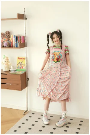 Pink floral teddy bear pinafore midi dress with ruched front detail, side pockets, and overall style straps