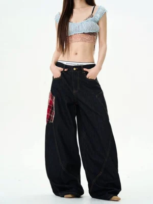 Front view of dark indigo plaid patch wide-leg denim cargo pants with red plaid thigh pocket and oversized streetwear silhouette