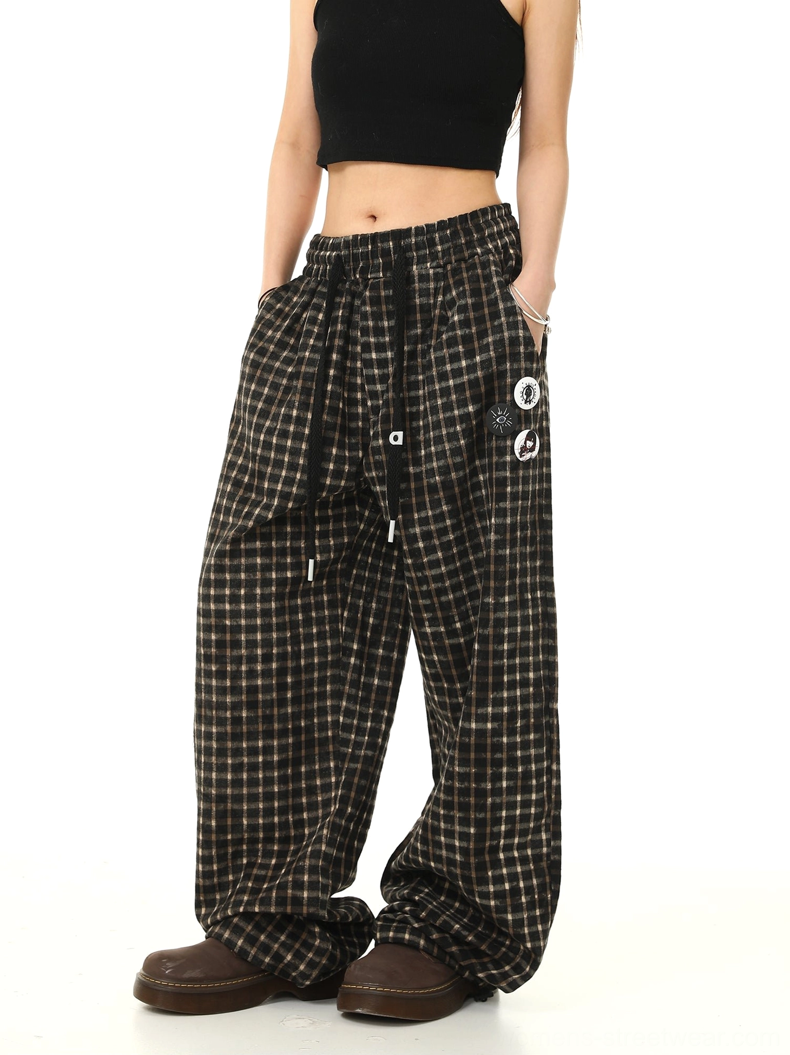 Side view of long plaid wide-leg streetwear trousers showing the full grid pattern side pocket and floor-length stacked hem