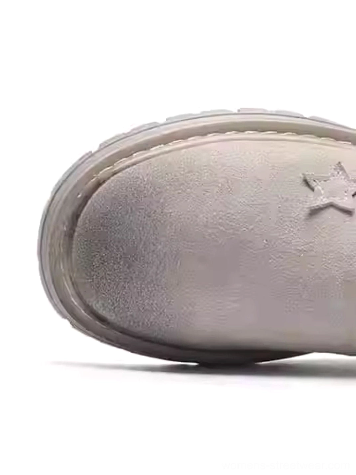 Platform boots toe cap and thick lug rubber outsole top-down front view showing star decorative detail and deep tread pattern