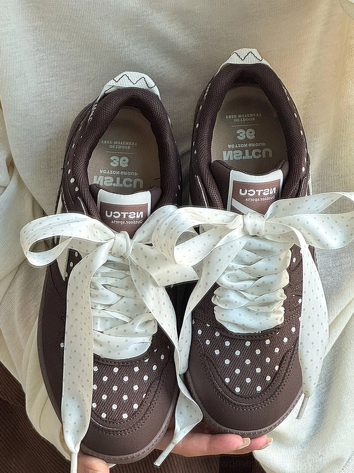 Close-up product image of playful polka dot ribbon low top sneakers for women's street fashion