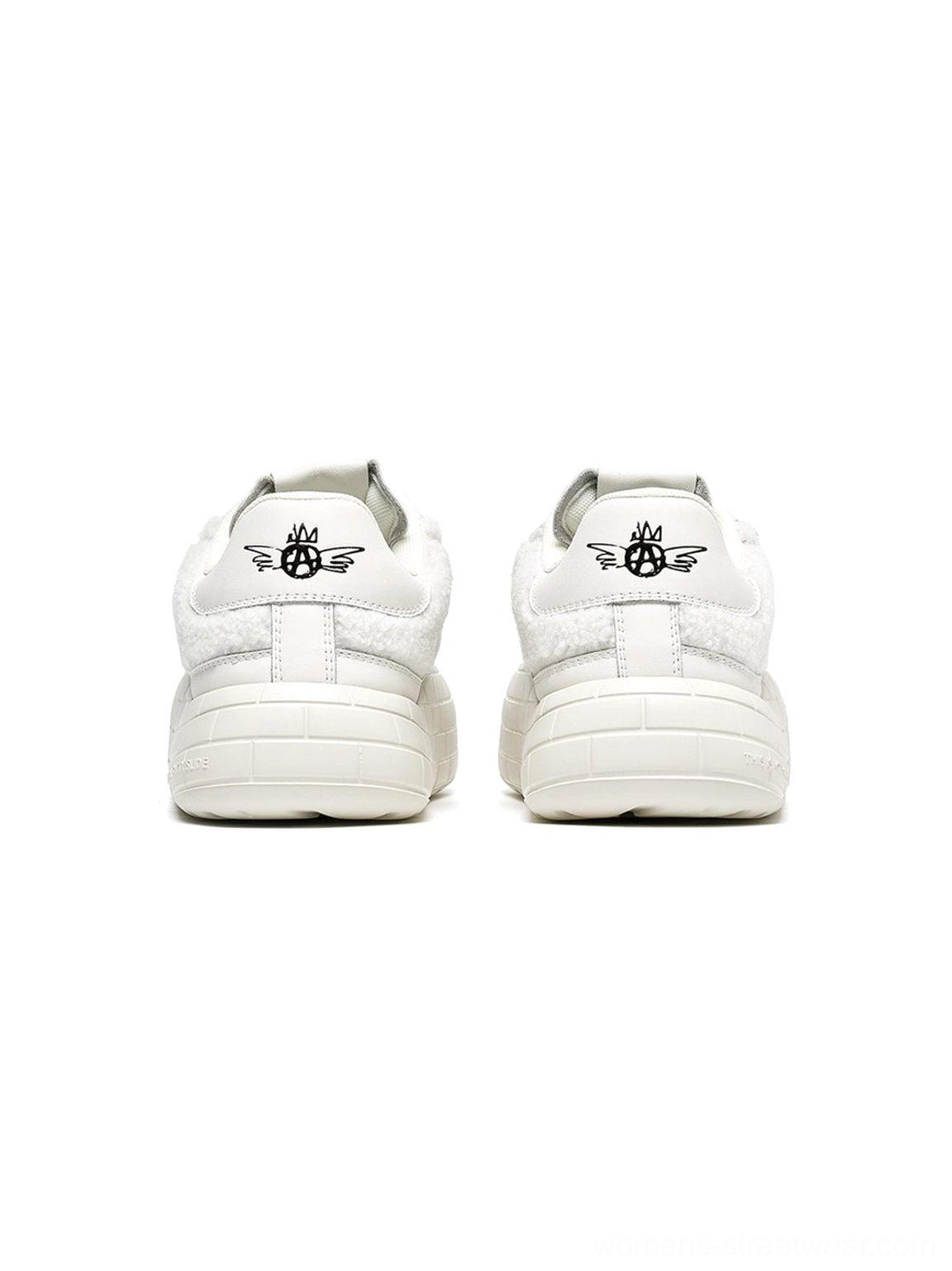 Plush black platform sneakers with thick sculpted soles for contemporary women's streetwear wardrobes