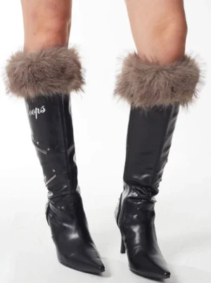 Model wearing black plush cuff pointed-toe stiletto knee-high boots back view with taupe fur collar y2k streetwear style