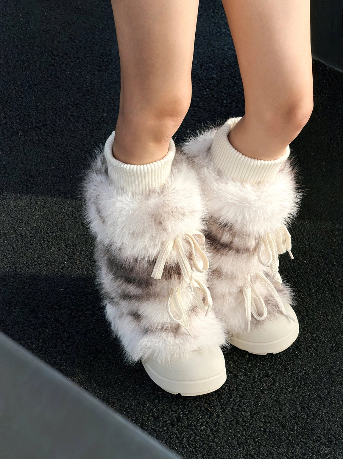 Plush-lined tall platform boots in black and white streetwear footwear detail view
