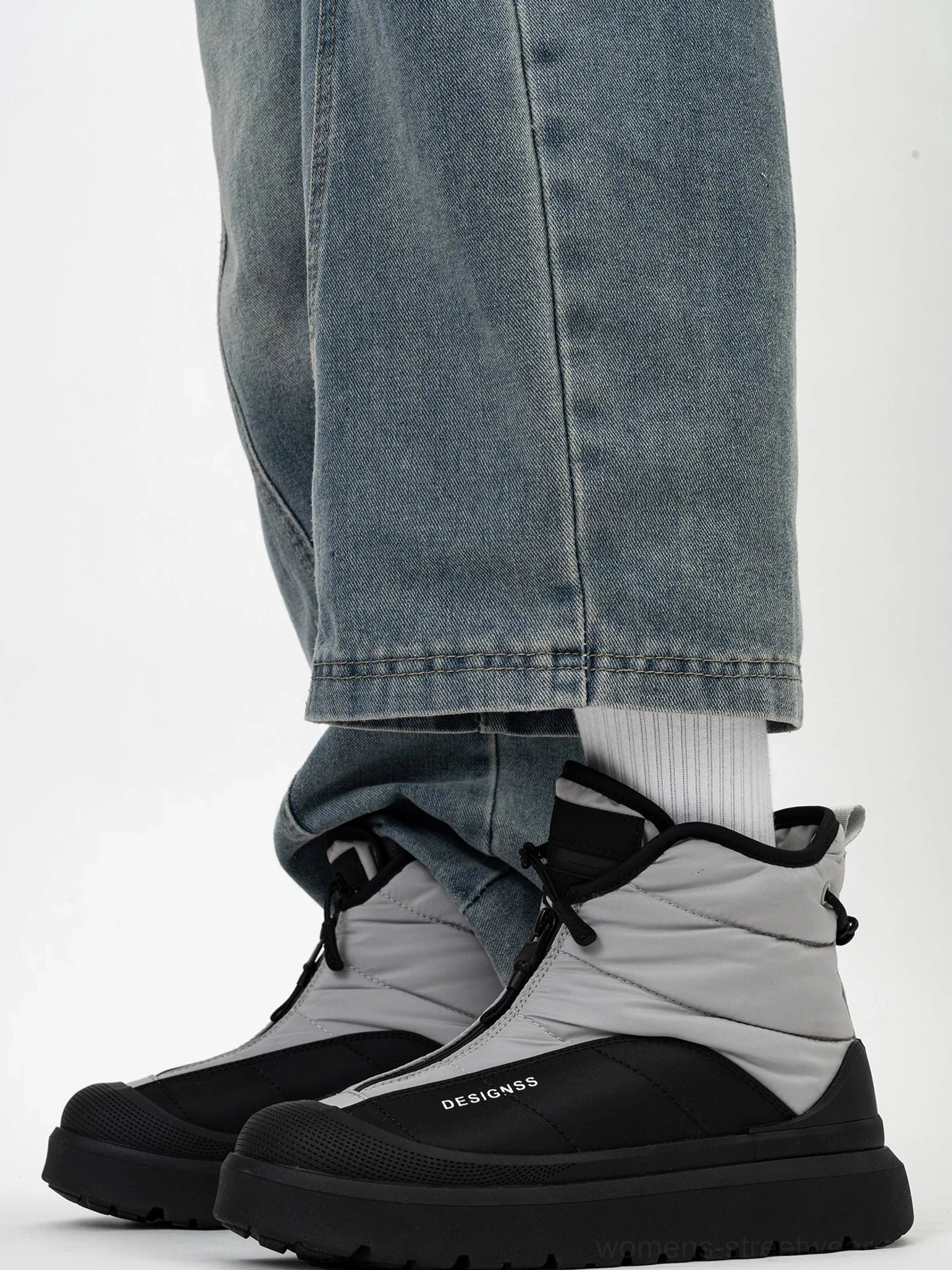 Front side view of black and gray fleece lined zip-up snow boots with ankle drawcord toggle, quilted upper, and thick rubber platform outsole
