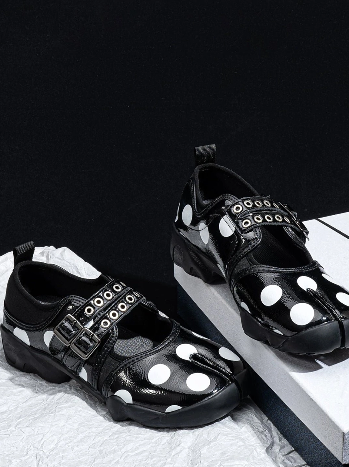 Polka dot Mary Jane sneakers showing the split-toe front, adjustable straps, and low-profile shape
