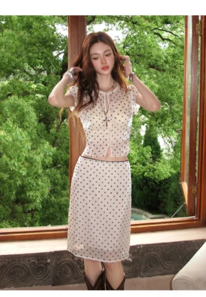 Front view of beige sheer polka dot mesh crop top and high waisted midi skirt streetwear set with black dots