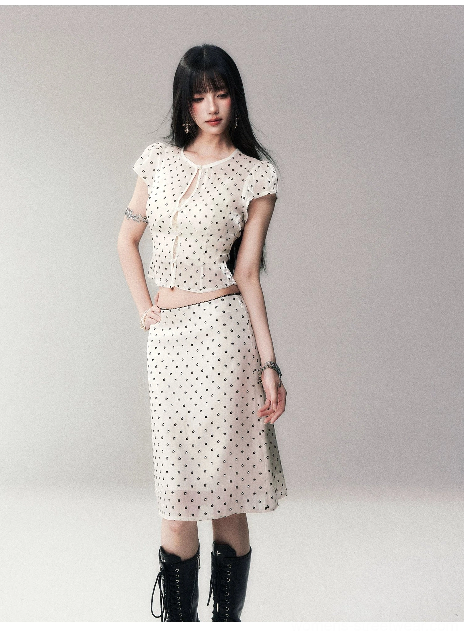 Full body view of polka dot mesh crop top and midi skirt styled with black platform combat boots