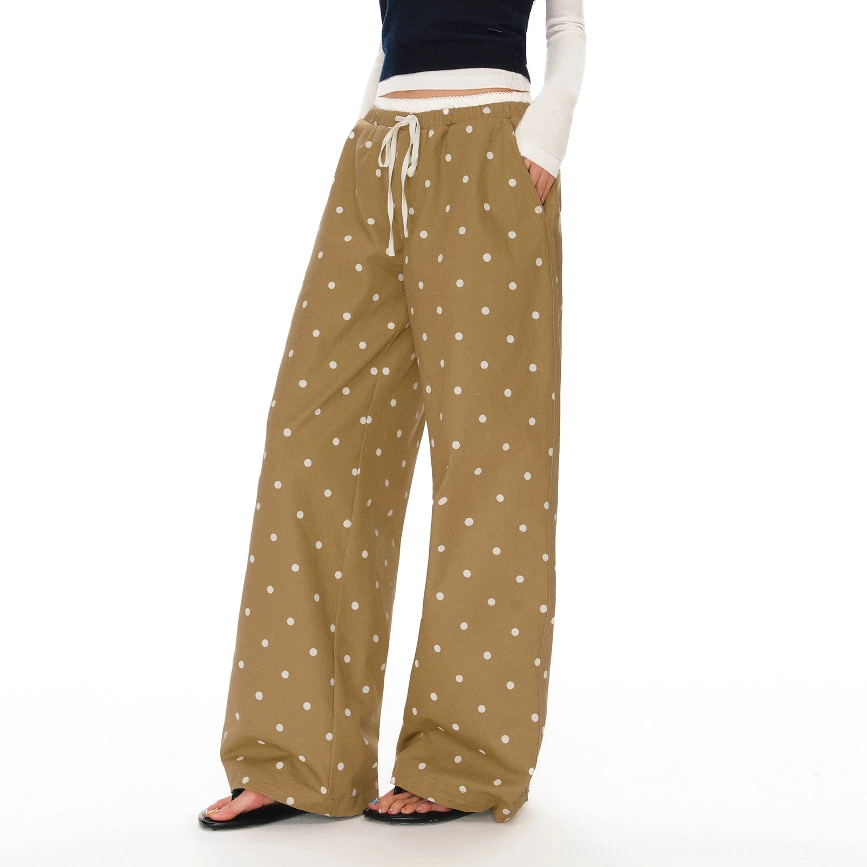 Close-up of polka dot pants twill cotton fabric showing the retro print, drawstring waistband, and side adjuster detail