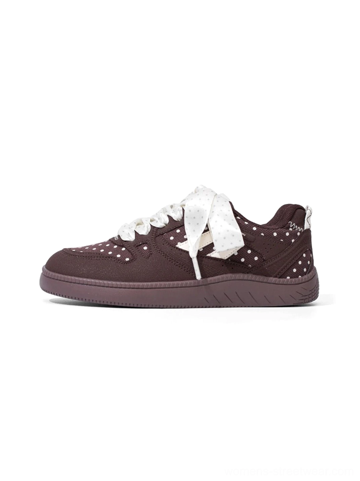 Brown polka dot ribbon low top skate sneakers with contrast panels and thick flat outsole on a white background