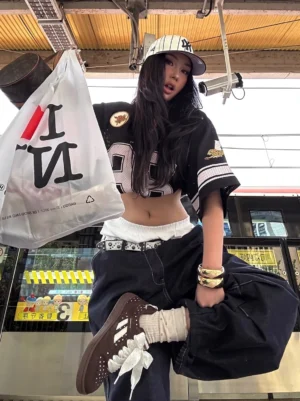Brown polka dot ribbon skate sneakers styled with a casual women's streetwear outfit on a subway platform