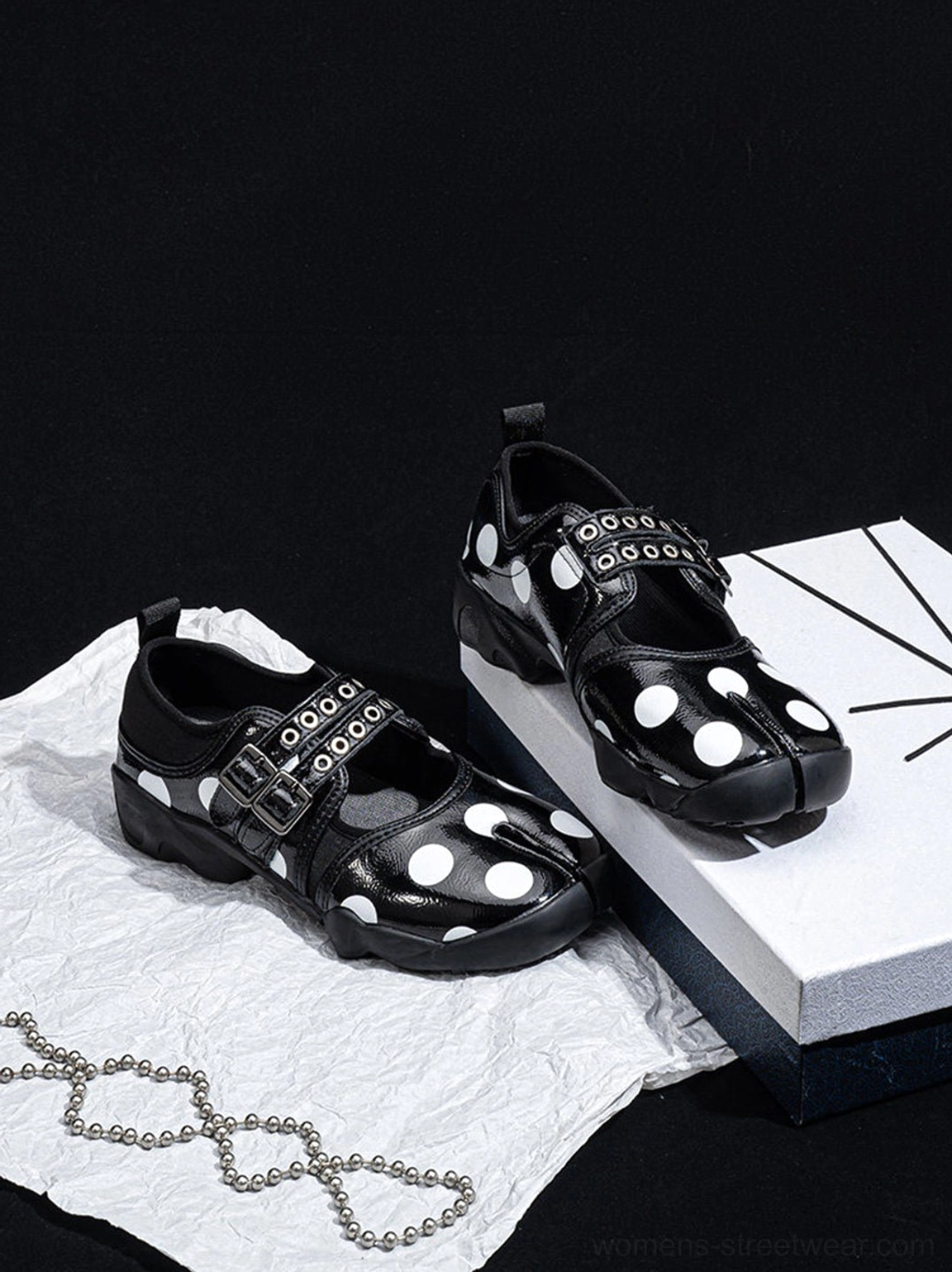 Polka dot split-toe Mary Jane shoes displayed in a detailed product photography view