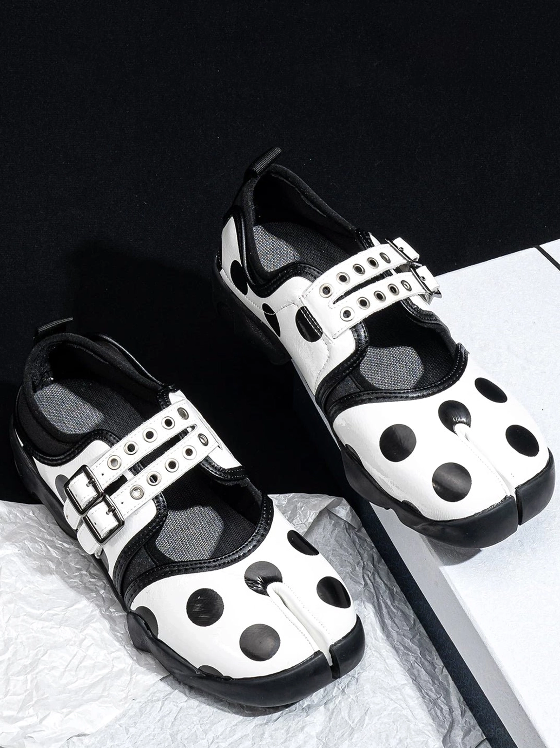 Overhead product view of polka dot split-toe Mary Jane sneakers showing the patterned upper and rugged outsole