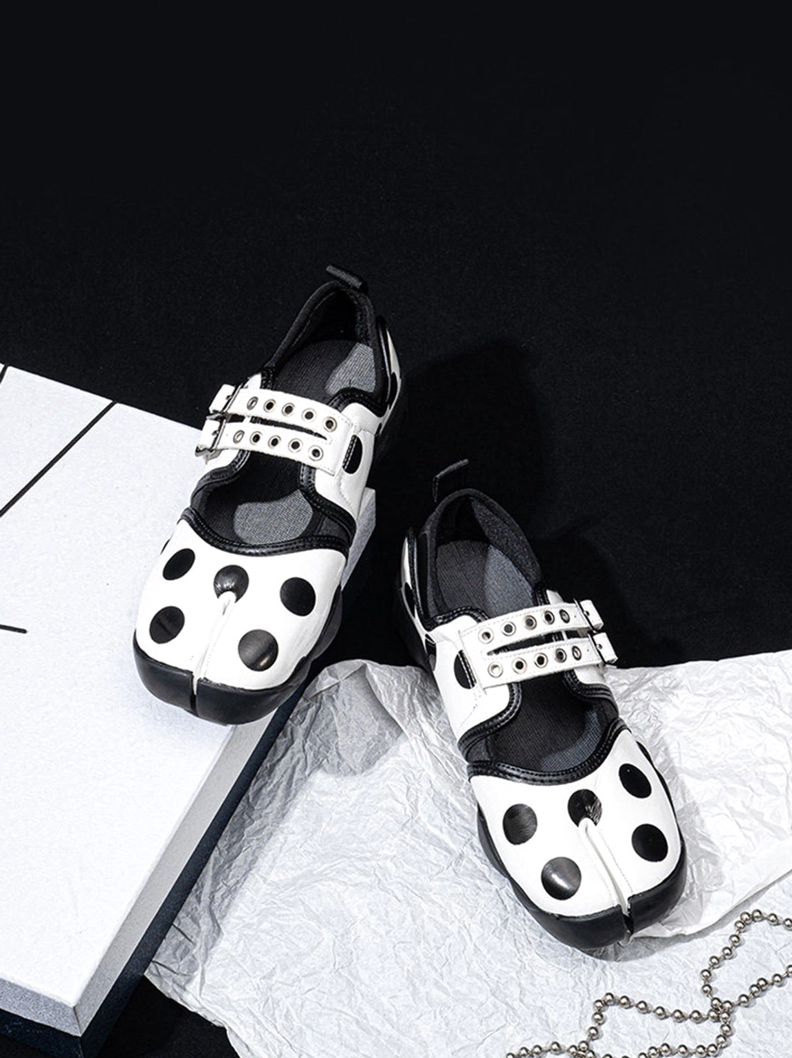 Side view of polka dot split-toe Mary Jane sneakers with adjustable straps and rugged black rubber outsole