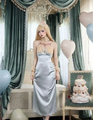 Back three-quarter view of powder blue satin slip maxi dress with slim silhouette in a vintage inspired bedroom setting