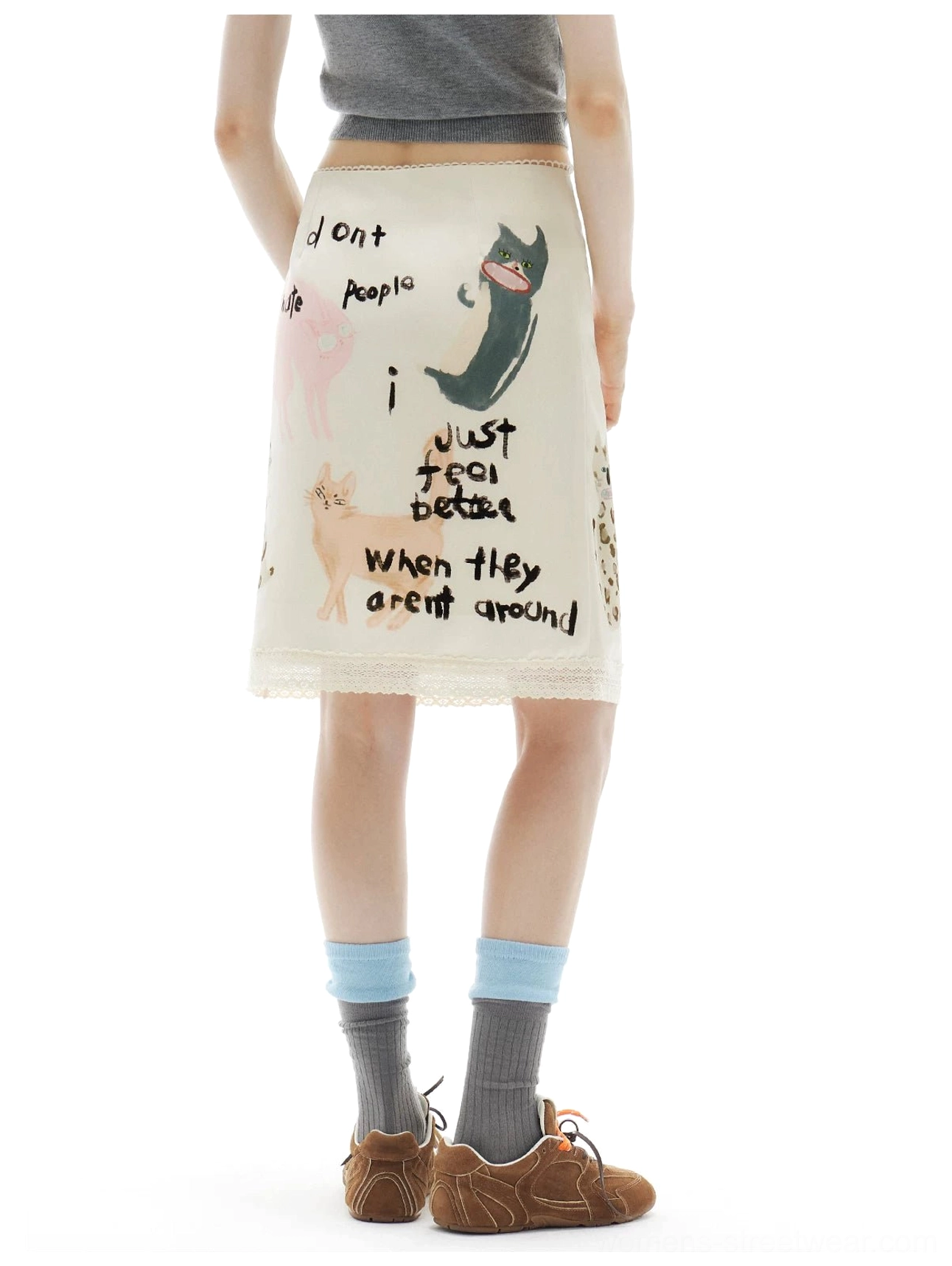 Back detail of the printed kitty midi skirt showing its tapered pencil silhouette, lace accents, and continuous handwritten artwork