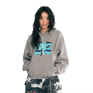 Heather gray Puppy House oversized graphic hoodie with blue puppy illustration styled with camouflage wide-leg streetwear pants