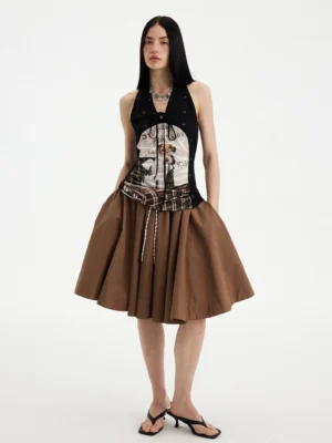 Full body front view of a brown multi puppy print plaid halter top with black polka dots, tie-up neckline, and matching brown skirt