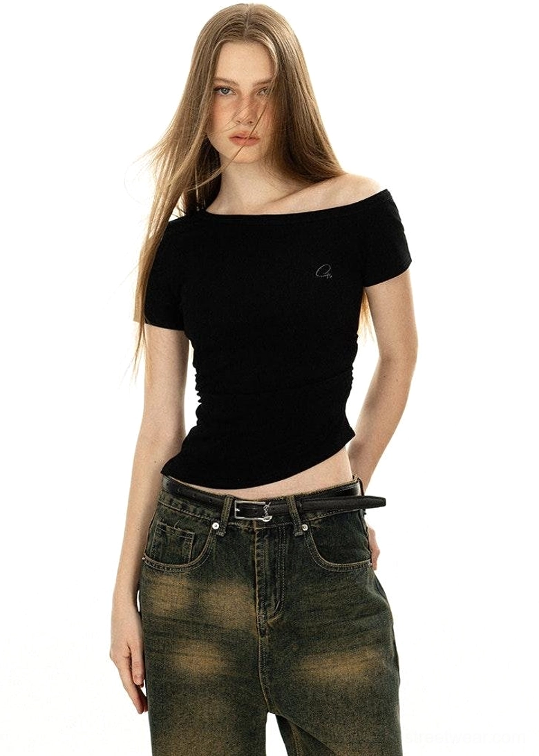 Front half-body pure black off-shoulder basic tee boat neckline short sleeves embroidered chest logo with dark faded jeans black belt