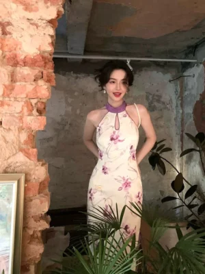 Front view of purple floral halter qipao inspired midi dress with Mandarin collar and keyhole neckline