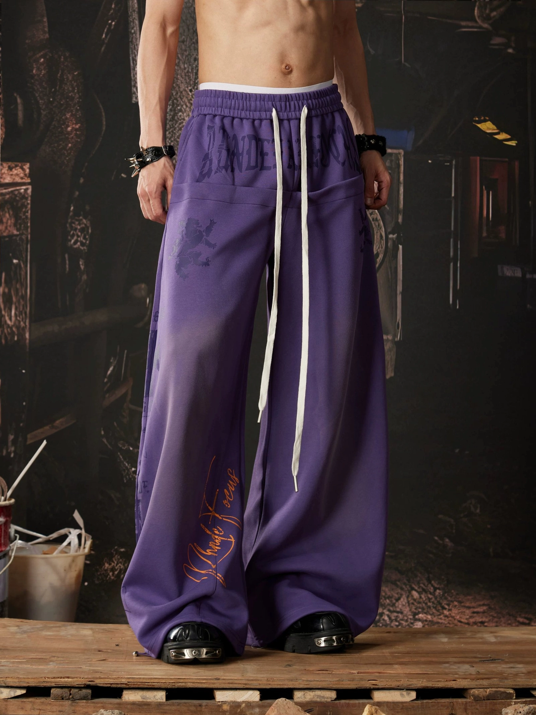 Purple graffiti streetwear wide leg sweatpants with handwritten signature graphics, gradient color, adjustable drawstring waist, and oversized Y2K fit