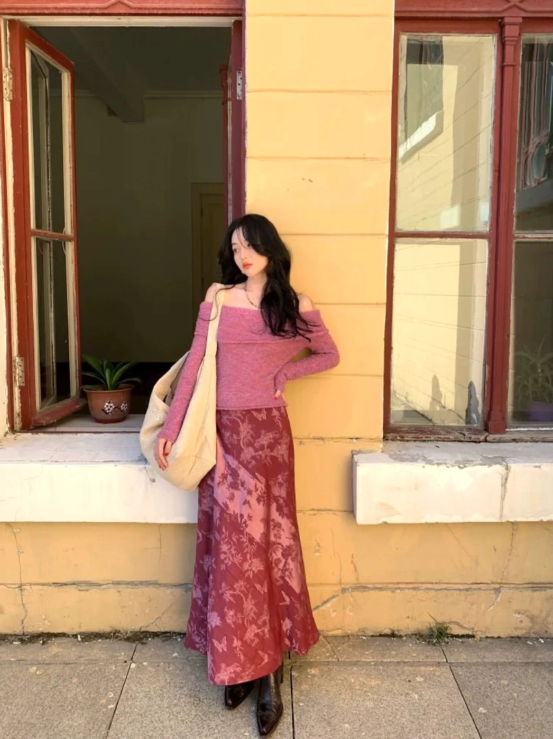 Purple off-shoulder long-sleeve knit sweater top paired with a floral satin maxi skirt in a romantic streetwear outfit