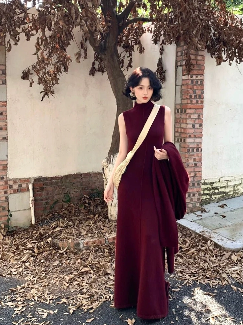 Purple sleeveless mock neck maxi knit dress with a fitted full-length silhouette styled in an outdoor Seoul streetwear setting