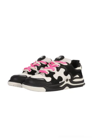 Black and off-white puzzle panel suede skate sneakers with hot pink flat laces and chunky rubber streetwear sole shown from an overhead front angle