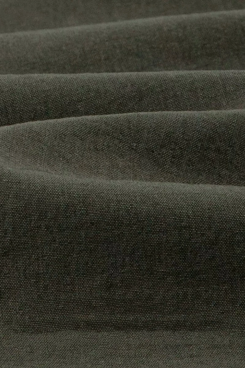 Close-up detail of dense lightweight woven cotton fabric in dark olive green from the quick-dry streetwear shorts