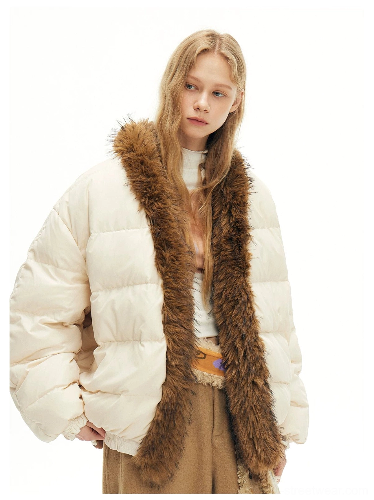 Three quarter view of quilted beige faux fur trim puffer bomber jacket with a warm neutral streetwear aesthetic