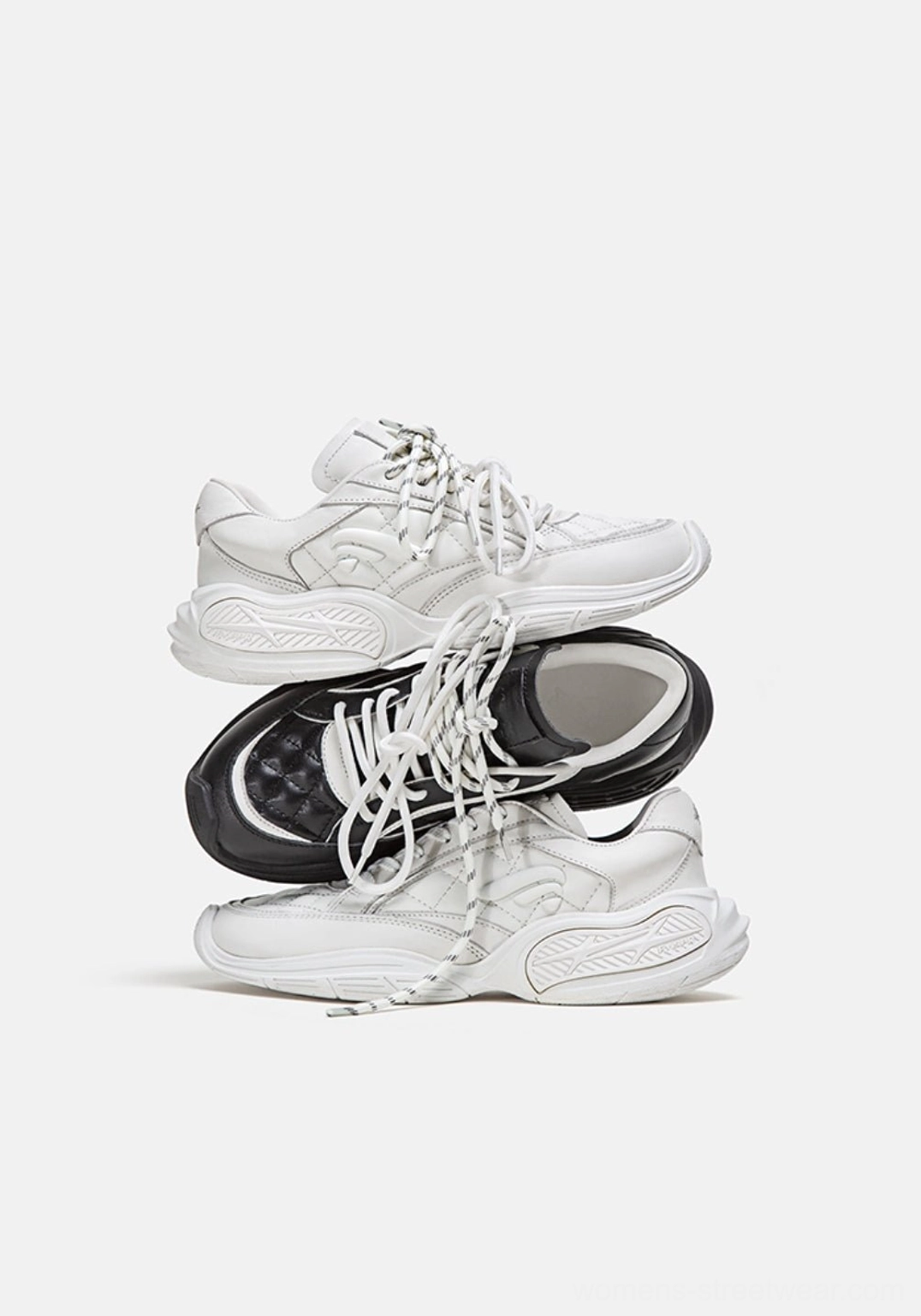 Quilted leather low-profile sport sneaker product image highlighting the black and white streetwear color-block design