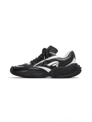 Black and white quilted leather low-profile sport sneakers shown from the left side on a clean studio background