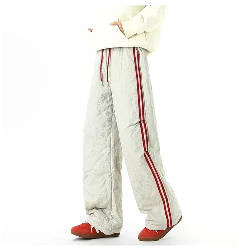 Front view of light gray padded wide-leg track pants featuring diamond quilting, drawstring waist, and red side stripes