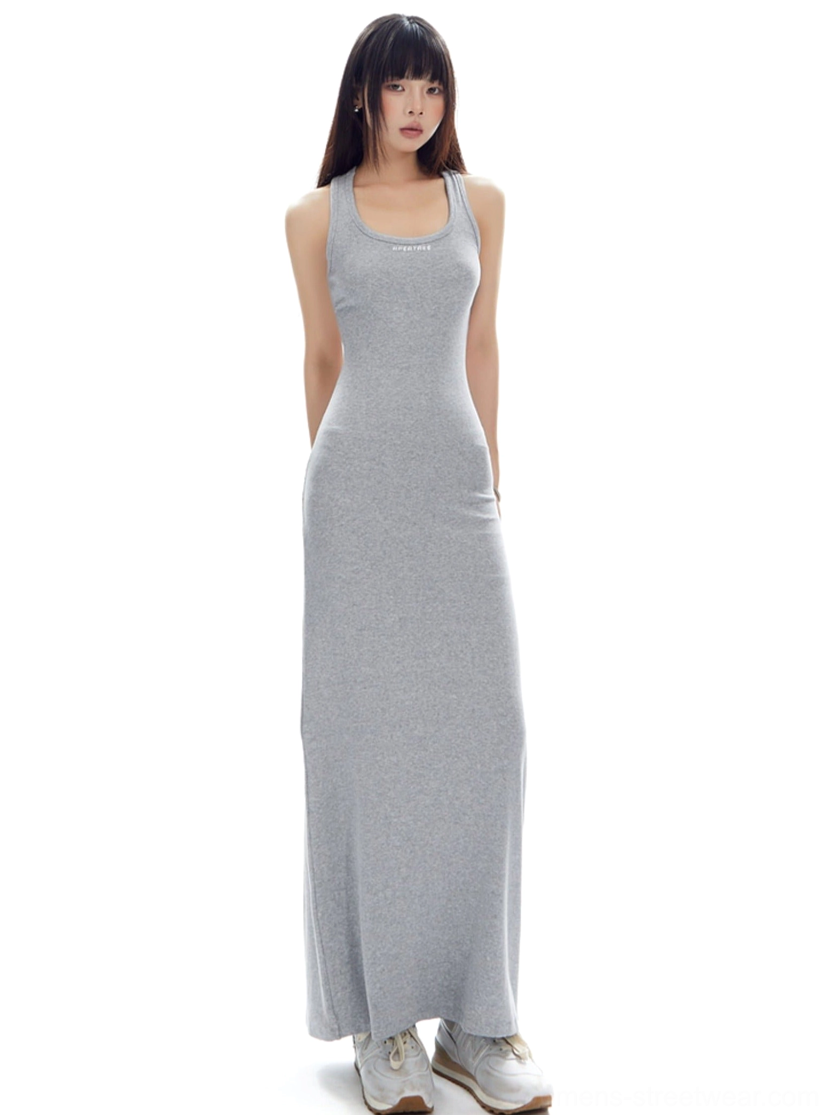 Light gray racerback open back ribbed maxi dress styled with casual sneakers in a right side studio view