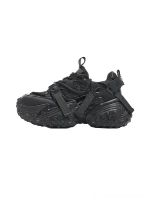 Black racing-inspired chunky sport sneaker with mesh upper, cross straps, and rugged tire-tread outsole shown from the left side