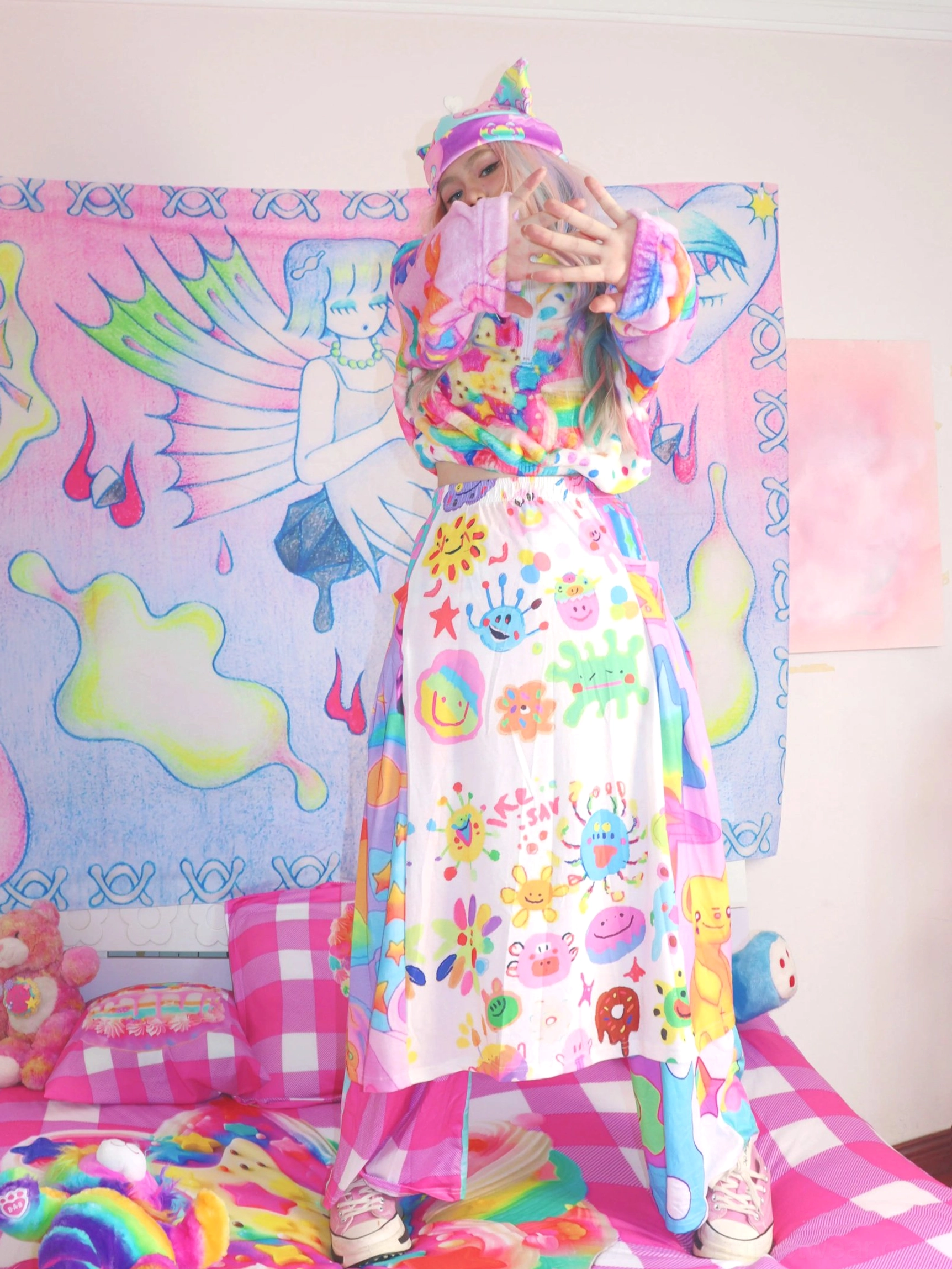 Rainbow doodle printed kawaii skirt styled with a cropped hoodie for a playful Y2K streetwear and Korean fashion inspired outfit