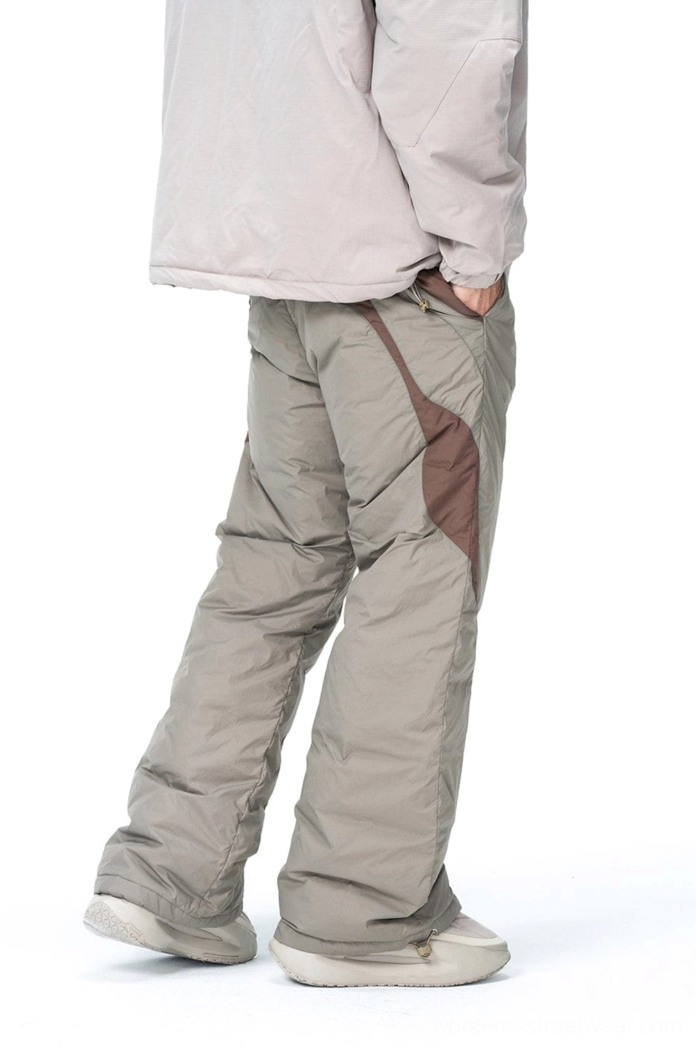 Rear side view of taupe and brown padded track pants with wide-leg cut decorative stitching and outdoor styling