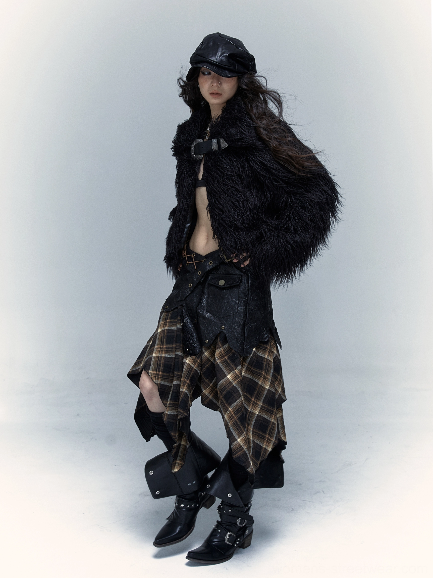 Dark punk tartan asymmetrical skirt outfit with layered plaid hem faux fur jacket newsboy cap and biker boots