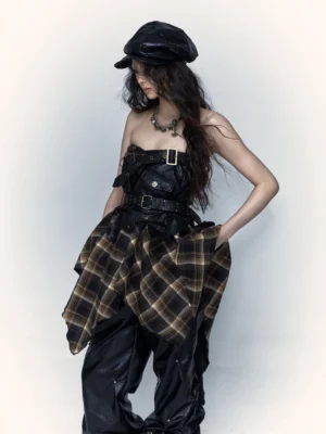 Women wearing brown black and yellow tartan asymmetrical punk midi skirt with buckled faux leather waist panel in side front studio view