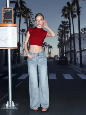 Front view of a red backless tie-back ribbed stretch crop tee styled with wide-leg jeans and red sandals on a city street