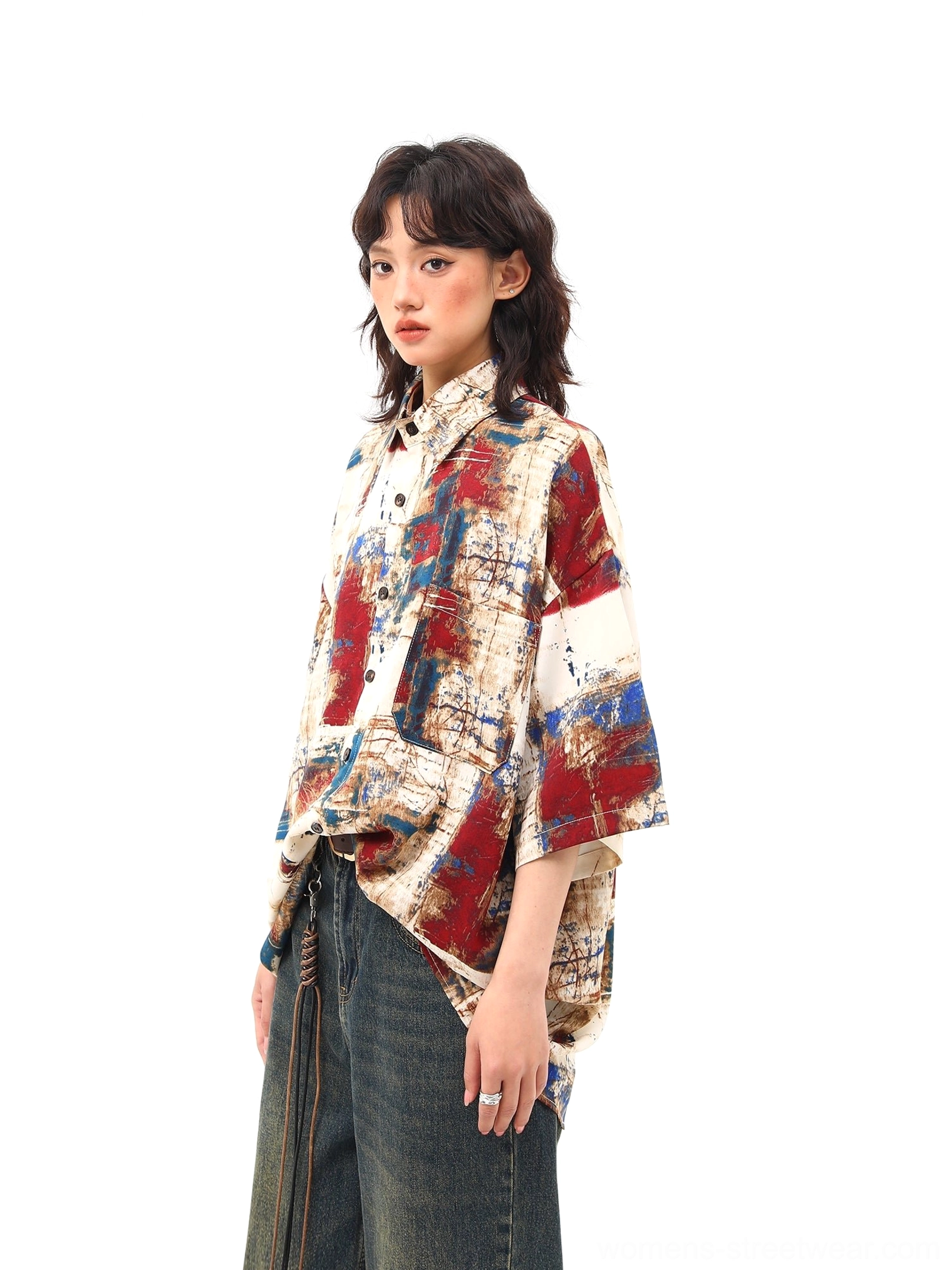 Side view of red blue abstract print oversized short sleeve shirt showing chest patch pocket and loose fit
