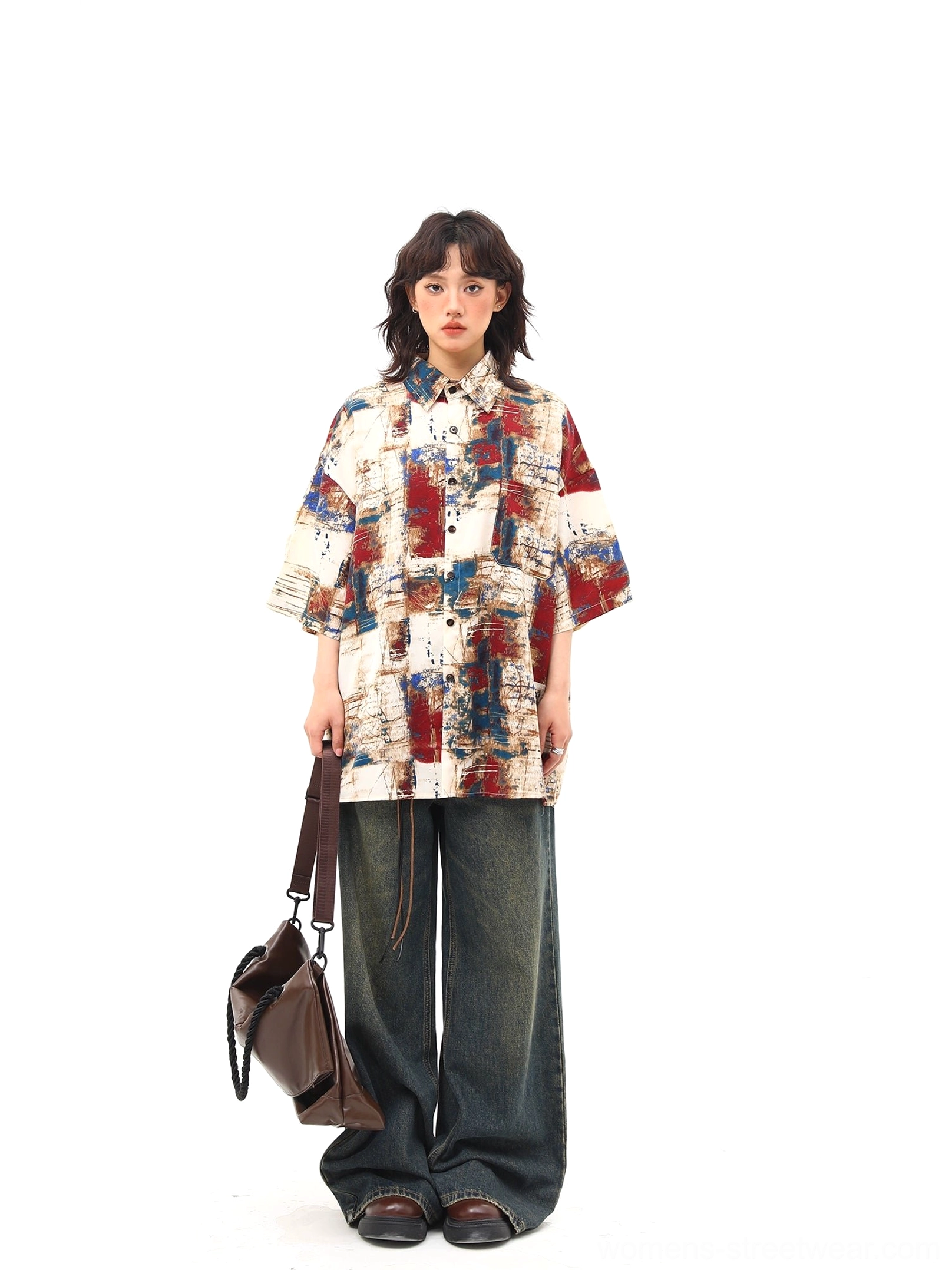Red and blue abstract print oversized short sleeve streetwear shirt front view styled with dark wide leg jeans