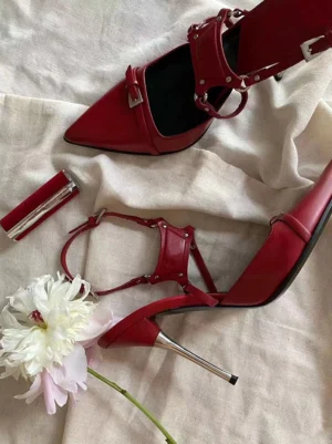 Red buckle-strap pointed-toe pumps with T-shaped ankle straps silver rivets and slender 8cm stiletto heels