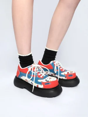 Women's red butterfly platform derby shoes styled with black ankle socks in a low front view
