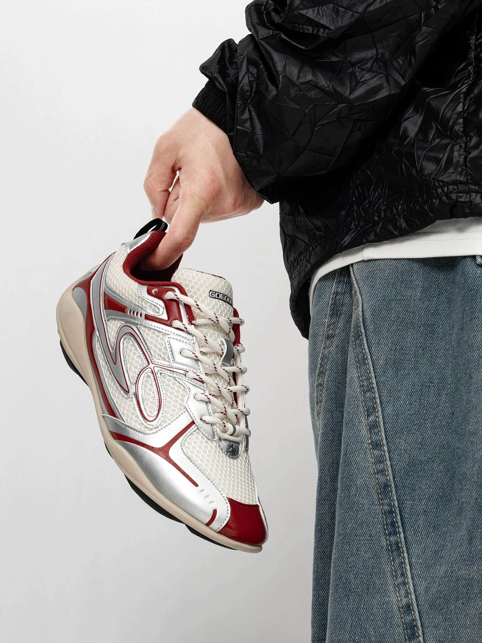 Red and cream vintage running sneaker with breathable mesh upper bright red metallic accents curved side detail and low-top lace-up design