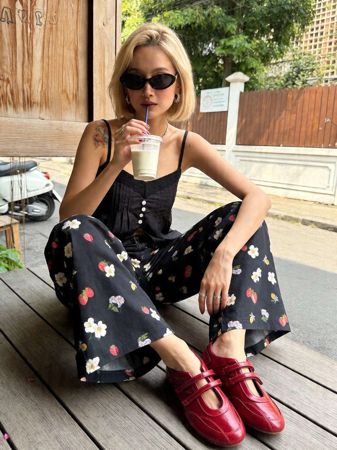 Seoul-inspired streetwear outfit featuring red crisscross strap ballet flats and wide-leg printed pants