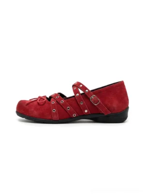 Red double strap studded bow ballet flats with silver hardware on white studio background